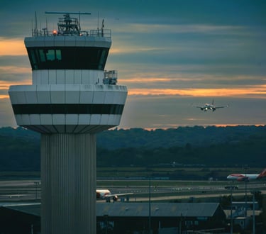 Air traffic control tower with an airplane ready to land on the runway at Gatwick Airport