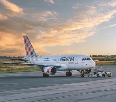 Volotea airplane on airport tarmac during sunset