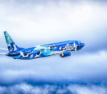 Alaska Airlines plane flies in the sky