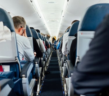 Interior of airplane with sitting people