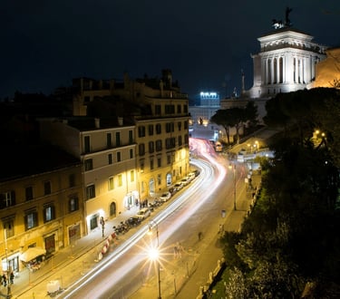 Rome at night with illuminated historic buildings and streetlights