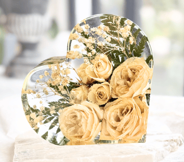 Preserved wedding bouquet with yellow roses in a heart-shaped resin block.