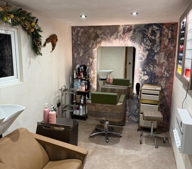Modern interior of a hair salon with microcement finish, professional chairs, backlit mirrors and ha