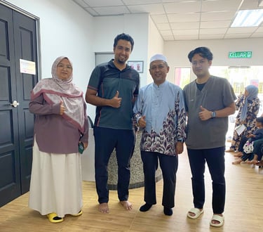 Satisfied patients and medical staff giving a thumbs up at a healthcare clinic office.
