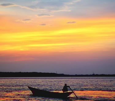 Man paddling at sunset on Ohio lake, reflecting Buckeye Venture Group’s real estate vision