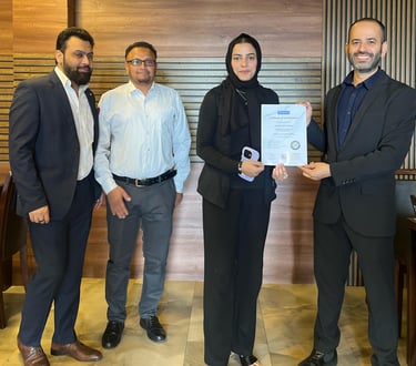 SESI Officials presenting a certificate of achievement to a female Personal trainer.