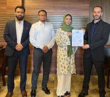 SESI Officials presenting a certificate of achievement to a female Personal trainer.