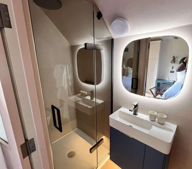 close-up of rainfall shower and tiled wall in Evesham bathroom