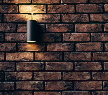 a brick wall with a light installed by pbp services in worcester 