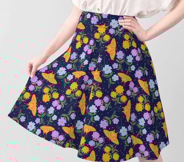 a woman in a white shirt and a butterfly floral printskirt