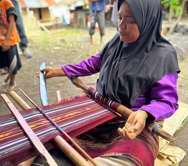 Artisan demonstrating Ikat weaving techniques in Uma Pura Village in alor