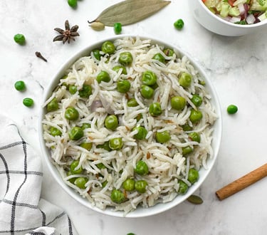 A fragrant rice dish bursting with sweet green peas, whole spices, and a touch of ghee.
