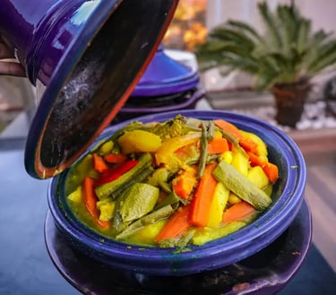 Vegetable tagine served from blue traditional Moroccan ceramic pot