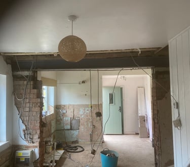 brick wall inside a house being taken out for a renovation by Lakes building and plastering services