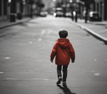 a young boy walking down a street in a city
