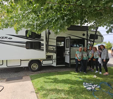 group of ladies in front of RV in matching shirts for their trip