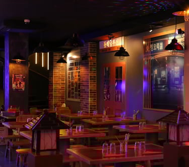 a restaurant with a large table and chairs