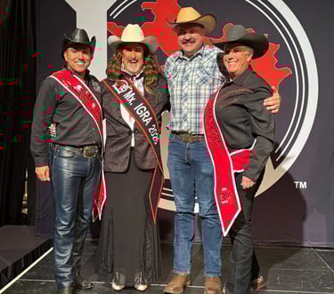 Four cowfolks standing on the Royalty stage. Three are in all black and one is in blue.
