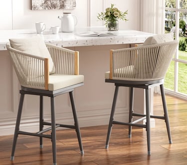 Modern outdoor swivel bar stools with rope woven backs and cream cushions at a white marble counter.