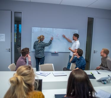 Medical device engineers collaborating at a whiteboard, demonstrating technical expertise