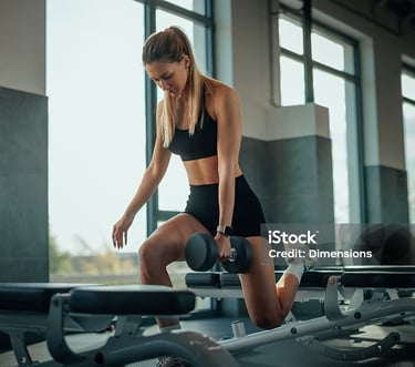 a woman doing a squat on a bench
