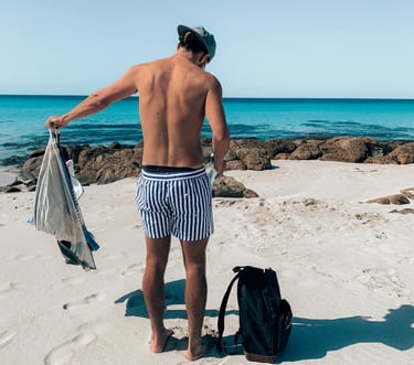 a man with his rucksack at the beach