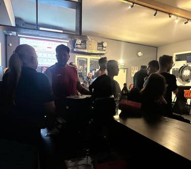 a group of people standing around a bar