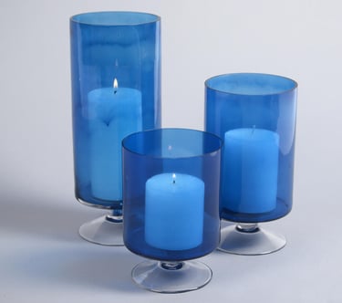three blue candles with candles in a glass vase & candle holder