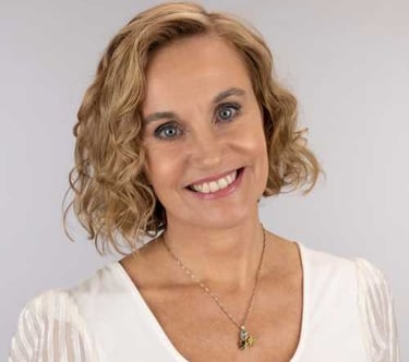 a woman with a necklace and a necklace with a flower, dori best