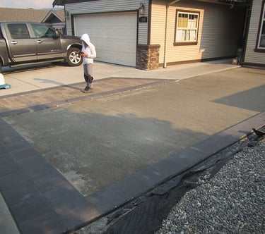 Crushed rock is spread, and compacted.