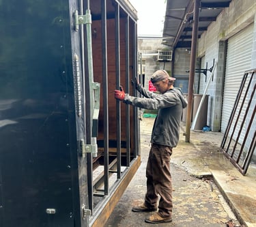 a man standing next to a trailer frame door