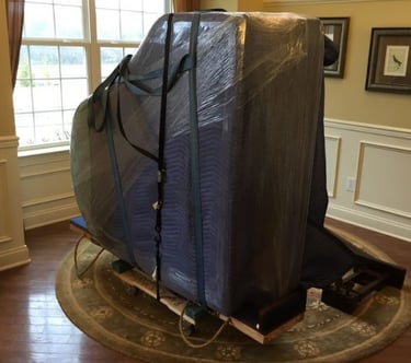 Grand piano prepped for moving by Swift Movers’ experienced heavy item team