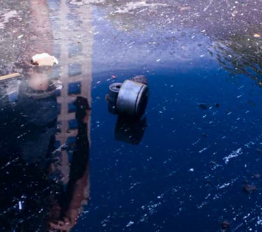 a fire hydrant sitting in the middle of a puddle