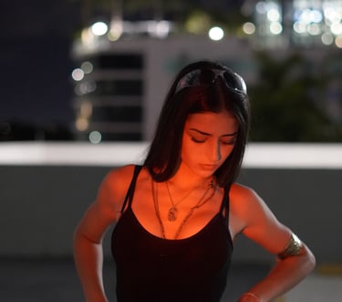 Miami lifestyle portrait of a woman in black tank top and gold jewelry at night by Frank