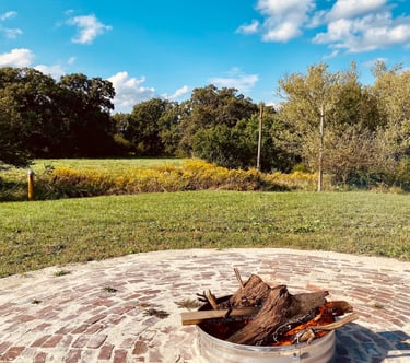 a fire pit in a circular brick patio