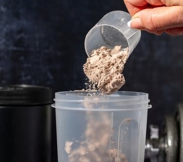 protein powder being poured into a cup