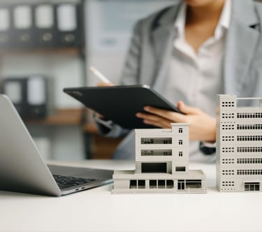 a woman in a business suit is holding a tablet and a tablet