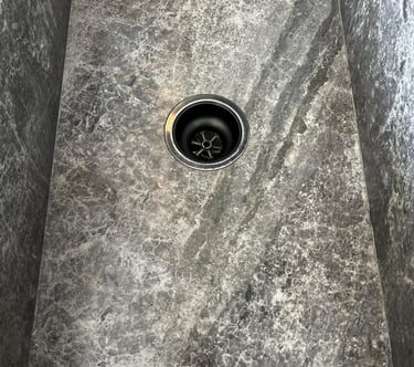 Custom stone sink cutout and installation with precise drilling for tap outlets in Melbourne