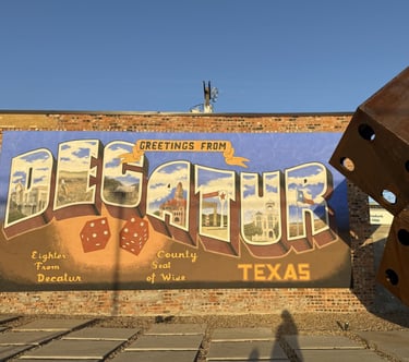 Decatur mural that says "Greetings from Decatur Texas. Eighter from Decatur. County seat of Wise."