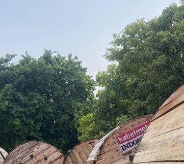 a bunch of wooden barrels stacked on top of each other kabel metal untuk listrik