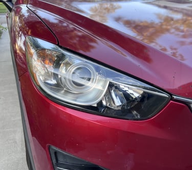 After image of shiny red car's headlight