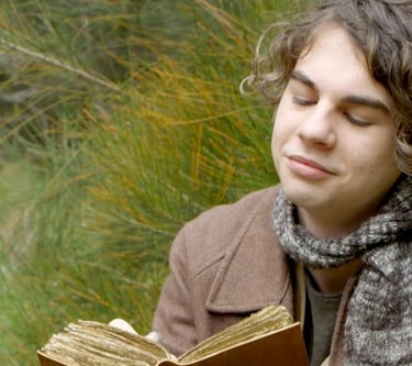 a man in a brown jacket is holding a book