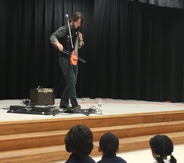 cellist Wytold performs at a school