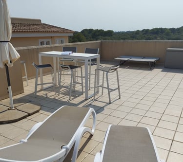 a patio with chairs and umbrellas on a sunny day