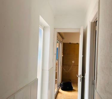 a hallway with a suitcase on the floor