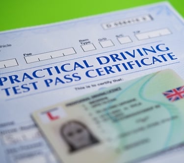 UK practical driving test pass certificate and a provisional license card on a green background.