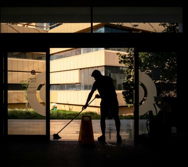A cleaning staff is cleaning a commercial location.