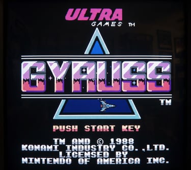 Gyruss title screen for NES by Ultra Games, featuring a 1988 Konami license on a CRT monitor.