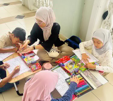 A teacher in a hijab helps children with a coloring activity using bright colored pencils.