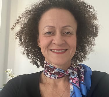 a woman with curly hair and a scarf around her neck